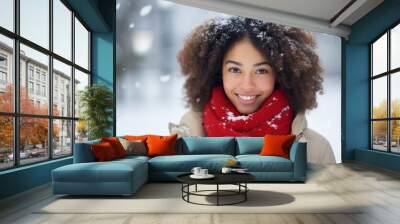 close up of a beautiful african american young woman with red scarf smiling on blurred snowy winter  Wall mural