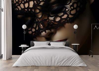 Close up of a beautiful mysterious young woman with black lace mask over her eyes on black background. Wall mural