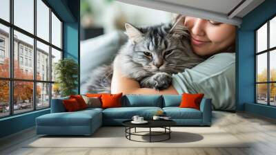 Close up of gentle young asian woman hugging cute grey persian cat on couch in living room at home, Adorable domestic pet concept, with copy space for text. Wall mural