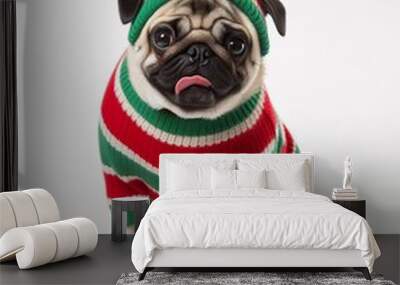 Cute pug dog wearing Christmas sweater and red beanie with fluffy red ball sitting happily isolated on white, funny new year animal portrait. Wall mural