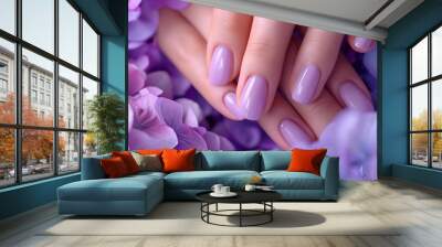 Glamour woman hand with trendy lilac color nail polish manicure on fingers, touching light purple spring flower petals, close up for cosmetic advertising, feminine product, romantic atmosphere use. Wall mural