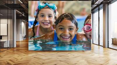 Group of happy kids learning swimming in indoor summer pool. Happy children kids group at swimming pool class learning to swim, happy summer vacation. Wall mural