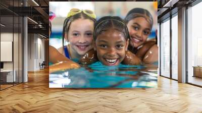 Group of happy kids learning swimming in indoor summer pool. Happy children kids group at swimming pool class learning to swim, happy summer vacation. Wall mural