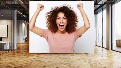 Happy young woman successful to get scholarship, clenches fists, accomplishes goal, exclaims finally victory, stands amused isolated on white background. Success, cheer and achievement concept Wall mural