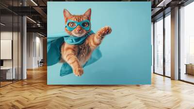 superhero cat, Cute orange tabby kitty with a blue cloak and mask jumping and flying on light blue background with copy space. The concept of a superhero, super cat, leader, funny animal studio shot. Wall mural