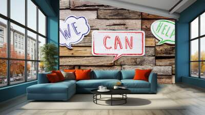 speech bubbles on wooden background : we can help Wall mural