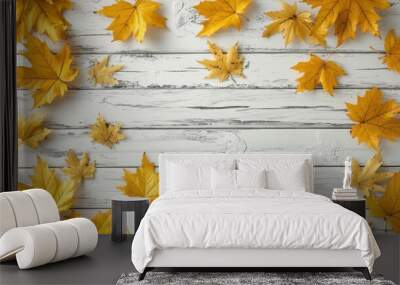 Autumn background made of yellow maple leaves on a white wooden tabletop, flat lay, copy space concept.  Wall mural