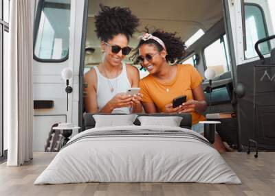 Women, road trip or phone for social media, gps location or map app for safari game drive or summer travel. Smile, happy or bonding friends with 5g mobile technology in camper van in nature landscape Wall mural