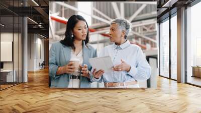 Business, tablet and mature woman with employee, talking and walking in modern office. Women, female administrator and manager speaking, conversation for schedule and leader in workplace or corporate Wall mural