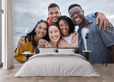 Friends, diversity and portrait at beach, ocean and outdoor nature for fun, happiness and travel. Group of happy young people at sea for holiday, vacation and smile for relaxing weekend trip together Wall mural