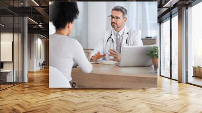 Healthcare, consultation and doctor talking to woman in after checkup, medical appointment and diagnosis. Wellness, support and medical worker in discussion with female patient in hospital or clinic Wall mural