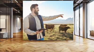 Point, cow or agriculture man with tablet on farm for sustainability, production or industry growth research. Agro, happy or farmer on countryside field for dairy stock, animals or food with smile Wall mural