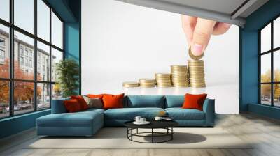 The hand was picking up the money that had been stacked up in layers. White background Wall mural