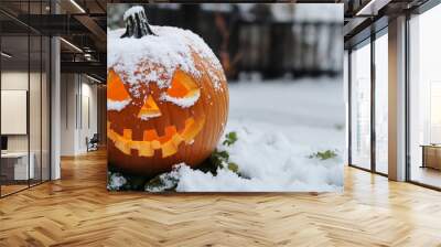 Halloween carved pumpkin covered in snow  Wall mural