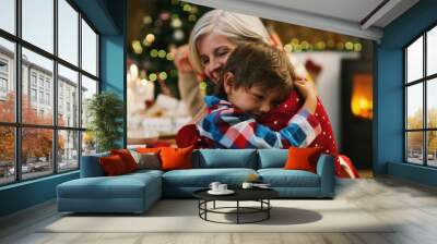 Christmas, love and a grandma hugging her grandchild in the home during the festive season together. Family, children or holiday with a young boy and senior woman in a house to hug while bonding Wall mural