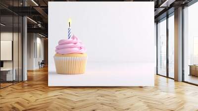 Single cupcake with lit candle on pink background Wall mural