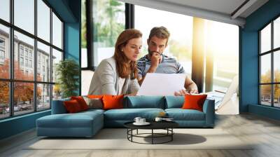 Couple, finance and budget conversation with documents planning for tax, bills and savings on laptop with banking, online payment and investment. People, financial thinking and household strategy Wall mural