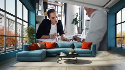 Lets first have a look at what the contract states. Cropped shot of two attractive young businesswomen filling out paperwork together inside an office. Wall mural