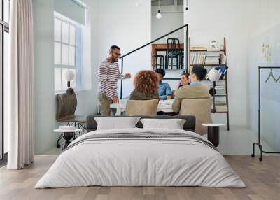 Success, youve gotta plan for it. Shot of a group of colleagues having a meeting in a modern office. Wall mural