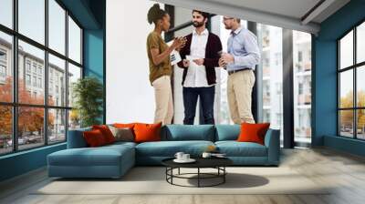 They never fail to come up with new ideas. Shot of a group of businesspeople having a discussion in a modern office. Wall mural