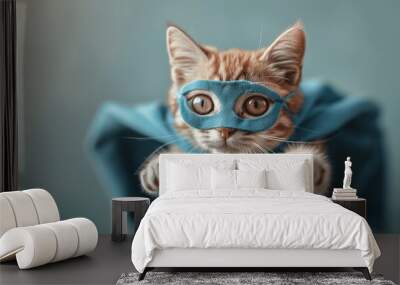 Superhero Cat in Blue Cloak Flying on Light Cyan Background, Cute Orange Tabby Kitty as Super Cat, Funny Animal Studio Shot with Copy Space Wall mural