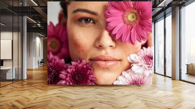 Flowers, woman and studio portrait for beauty, wellness and skincare with spring aesthetic by background. Model, girl and carnation plants for cosmetic health, healthy face glow or sustainable petals Wall mural