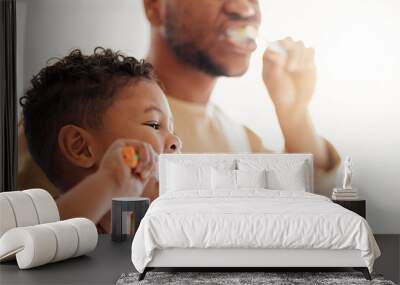 Brushing teeth, child and dad in a home bathroom for dental health and wellness. Face of a man and african kid learning to clean mouth with a toothbrush and toothpaste for oral hygiene and self care Wall mural