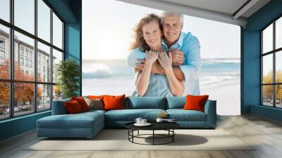 Senior, couple and portrait hug at the beach for happiness and bond in the outdoor. Mature, man and woman holding one another at the ocean with smile and love for vacation and travel in summer Wall mural