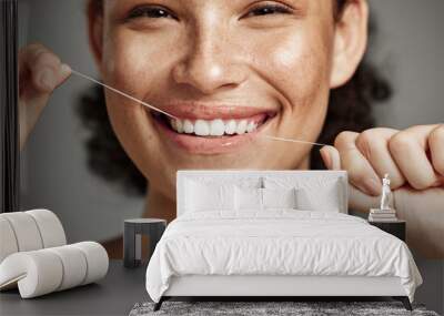 Woman portrait, dental floss and flossing teeth with smile for oral hygiene, health and wellness on studio background. Face of female happy about self care, healthcare and grooming for healthy mouth Wall mural