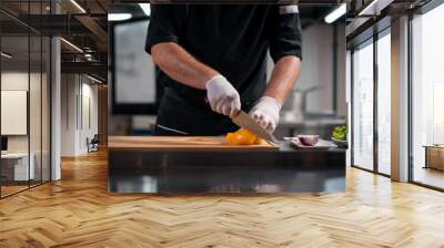 close up of chef cook hands in gloves cutting or chop yellow pepper at kitchen Wall mural