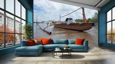 A fishing boat that ran aground in the coastal area due to low tide Wall mural