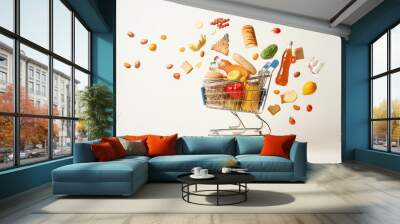 a shopping cart full of healthy food flying in the air on a white background Wall mural