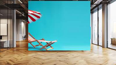 Beach chair and umbrella on blue wall background with copy space Wall mural