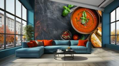 Tomato soup with basil, toast and olive oil is served on a cement floor Wall mural