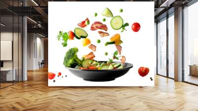 Vegetables fall into a black frying pan on a transparent background. Healthy food concept Wall mural