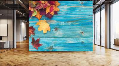 Autumn background with colorful leaves on wooden background Wall mural