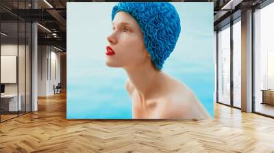 portrait of beautiful woman in pool cap by the water. Summer, swimming, wellness, recreation, travel concept Wall mural