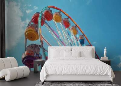 A colorful Ferris wheel against a blue sky with white clouds. Wall mural