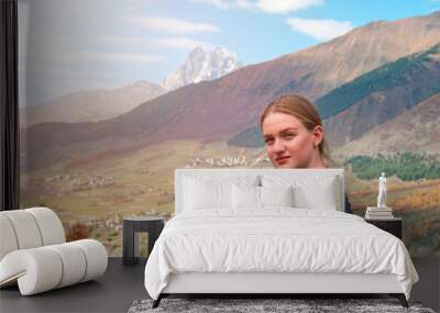 beautiful blonde girl on the background of Mount Ushba, mountains of Svaneti, Georgia Wall mural