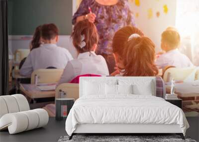 children actively participate in the class, read and listen to the teacher Wall mural