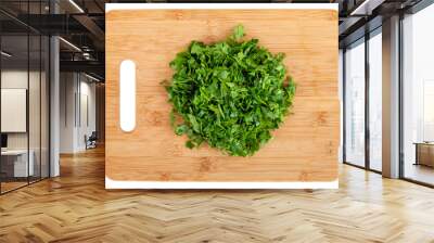 chopped parsley leaf on wooden a board isolated on white background, top view Wall mural