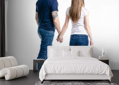 Man and woman hold hands goes on white background isolation, back view Wall mural