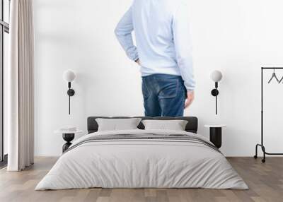 Man in jeans back behind on a white background. Isolation. Wall mural