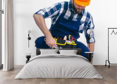 Man worker builder with helmet and tool belt, building level on white background isolation Wall mural