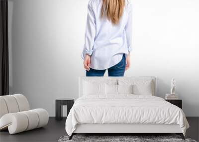 Woman in jeans and blue shirt goes on white background isolation, top view Wall mural