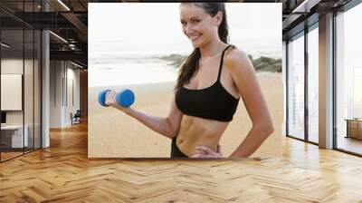 beautiful young woman exercising on beach Wall mural