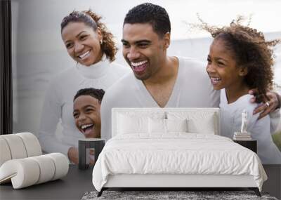 Happy African-American family with two children on beach Wall mural