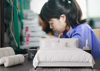 chinese female worker in assembling electronic device on factory Wall mural