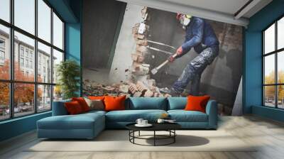 demolition work and rearrangement. worker with sledgehammer destroying wall Wall mural