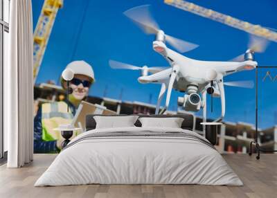 Drone operated by construction female worker on building site Wall mural